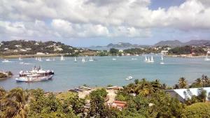 a group of boats in a large river with sailboats at Bayside Villa St. Lucia in Castries