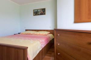 a small bedroom with a bed and a dresser at Apartmani Irena in Veprinac