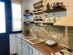 a kitchen with a sink and a counter top at Bekos traditional house in Archangelos +13 photos