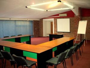 a conference room with a long table and chairs at Hotel Senator in Timişoara