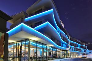 a building with blue lights on the side of it at Jupiter Marina Hotel - Couples & Spa in Portimão