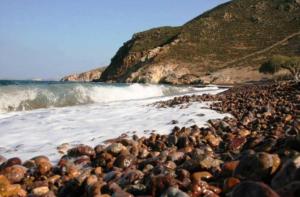 a large group of rocks on a beach at Lampi's House in Patmos