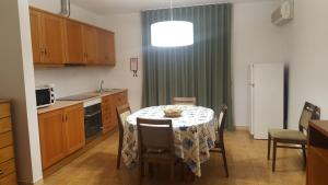 a kitchen with a table with a table cloth on it at Mira Parque in Albufeira