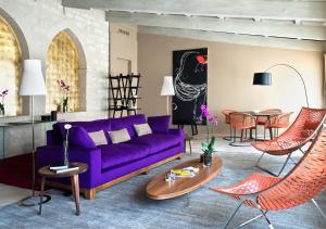 a living room with a purple couch and a table at Mercer Hotel Barcelona in Barcelona