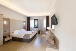 Postel nebo postele na pokoji v ubytování Hotel Boomerang Roma