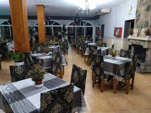 a dining room with tables and chairs and a fireplace at Nuevo Montesol in Málaga