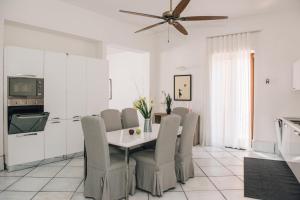 a kitchen and dining room with a table and chairs at L' Ambasciata Gaeta in Gaeta