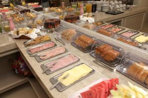 a buffet with many different types of food on a counter at Hotel Palace Frederico in Frederico Westphalen