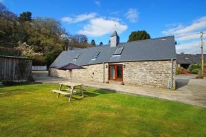 a picnic table in the grass in front of a building at Degwm in Llanwrin