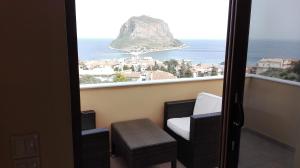 a balcony with chairs and a view of the ocean at Villa Cazala in Monemvasia