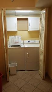 a small kitchen with a stove and a microwave at JeffsCondos - 4 bedroom - Dunes Village Resort in Myrtle Beach