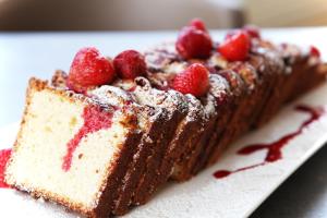 a piece of chocolate cake with strawberries on a plate at Warmthotel in Rome