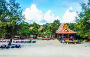 a building on the beach with chairs and a playground at Sol Beach Resort in Koh Rong Sanloem
