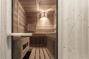 a sauna with wooden walls and a wooden floor at Artefugium Atelier - Apartments in Selva di Val Gardena