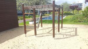 a playground with a swing in a park at The Galley in Lisbon