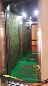 an elevator with a green floor in a room at Hotel Bucarica Plaza in Bucaramanga