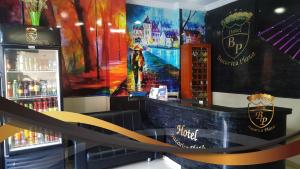 a bar with a painting on the wall at Hotel Bucarica Plaza in Bucaramanga