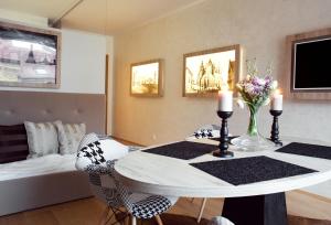 a room with a table with two chairs and a bed at Brunetti Design Apartment in Prague