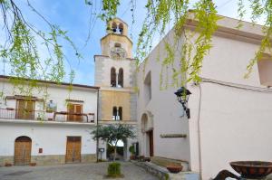 a building with a clock tower in a courtyard at Casa Pont1 Historic Pontone near Amalfi & Ravello in Scala