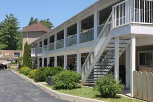 a building with a staircase in front of it at Saga Resort in Wasaga Beach