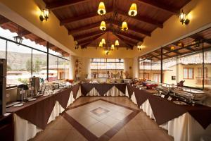 a large banquet hall with a long table in it at Hotel Mabey Urubamba in Urubamba