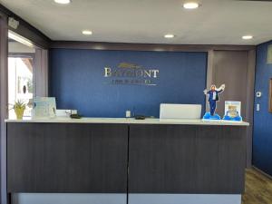 a man standing on a counter in an office at Baymont by Wyndham Cookeville in Cookeville