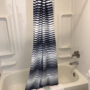 a blue and white shower curtain in a bathroom at Belfair Motel in Belfair