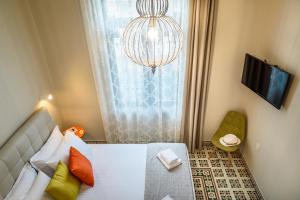 a bedroom with a bed and a chandelier at Mosaic in Chania