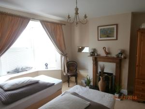a bedroom with a bed and a window at Riverside House in Bideford
