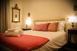a bedroom with a large white bed with red pillows at Domvs Gaia GHouse B&B in Vila Nova de Gaia