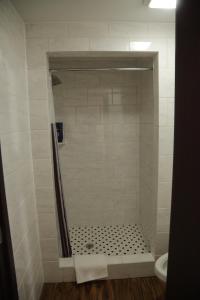a bathroom with a shower stall with a toilet at Theroff's Motel in Washington
