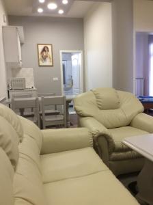 a living room with two chairs and a table at Apartman br 4 in Bijeljina