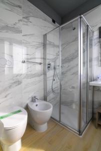a bathroom with a shower and a toilet and a sink at Hotel Ristorante Fortuna in Cavallino-Treporti