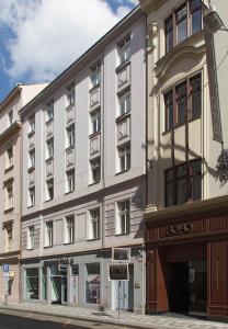 a large white building on the corner of a street at SeNo6 Apartments in Prague