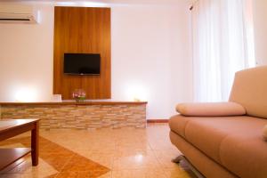 a living room with a couch and a tv at Apartment Volme in Pula