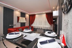 a living room with a table and a red couch at Apartment Lovac in Belgrade