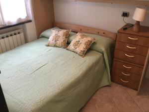 a bedroom with a bed with two pillows on it at La casetta della nonna in Sestri Levante