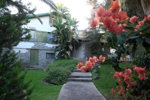 a house with a pathway in front of a yard at Bar Bakfar in Sharona