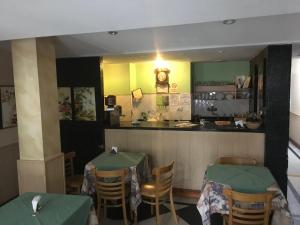 a restaurant with two tables and a counter at Hotel Condor in Buenos Aires