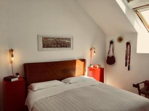 a bedroom with a bed and two night stands at Mansarda Bellini in Naples