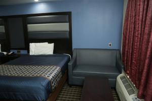Habitación pequeña con 2 camas y silla en Theroff's Motel, en Washington