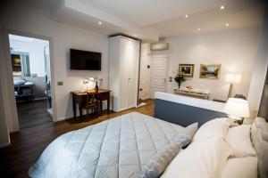 a bedroom with a large bed and a desk in it at Arena Suite in Verona