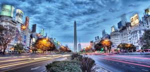 una strada cittadina con traffico notturno con edifici di Hotel Condor a Buenos Aires