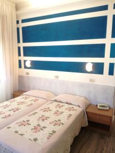 Postel nebo postele na pokoji v ubytování Hotel Prati