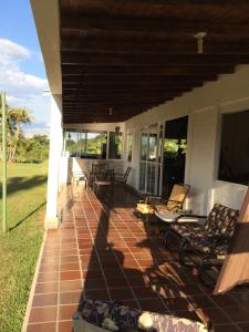 a porch of a house with chairs and tables at Finca La Ranchera No. 1 in Tarso