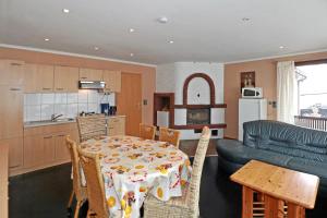 a kitchen and living room with a table and a couch at Pension A1 Stuckenborstel in Sottrum +9 photos