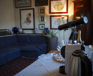 a living room with a blue couch and a telescope at La Terrazza Sui Tetti in Senigallia