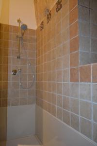 a bathroom with a shower with a tub at San Biagio Materapartment in Matera +22 photos