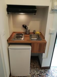 a small kitchen with a sink and a stove at Fondamente Nove 5201 in Venice