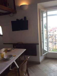 a dining room with a table and chairs and a window at Old castle S. Croce in Cagliari